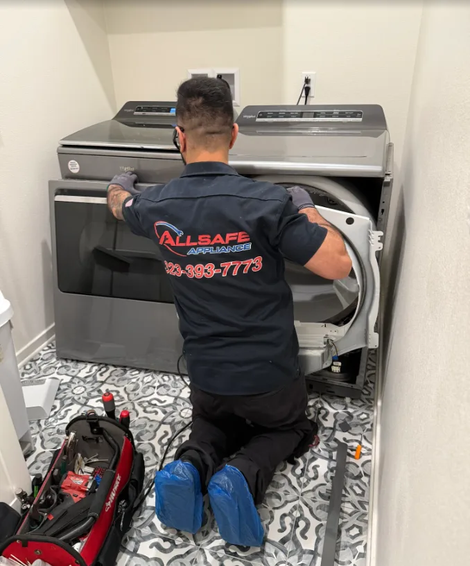 Allsafe Appliance technician repairing a dryer in a customer's home